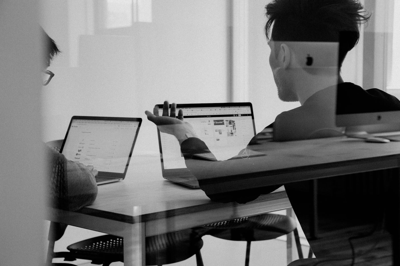 A workshop table laid out with notebooks and laptops ready for a portfolio proof workshop